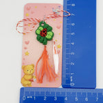 Martisor pentru Copii, Jolie, Model TRIFOI cu BUBURUZA, din Cauciuc, cu Snur Impletit Alb/Rosu, Ambalaj Carton cu